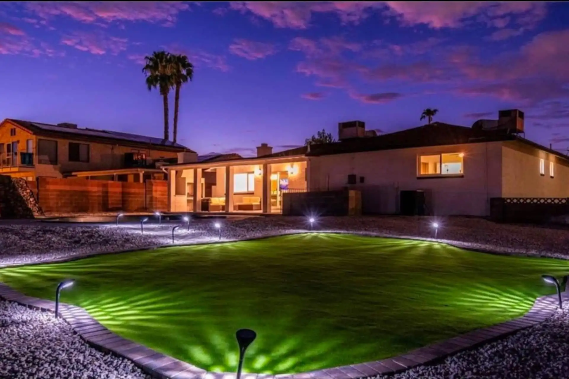 Shamrock backyard with illuminated lawn at night